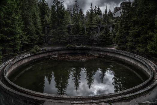 Mysterious forested basin reflection near Přebuz, Karlovarský kraj, with a moody atmosphere.