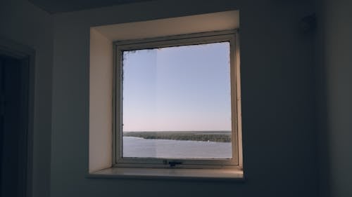 View of a Body of Water through a Window of a Building 