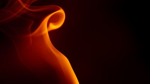 Free Dynamic abstract image of a flame with smooth, swirling curves and a warm orange glow. Stock Photo