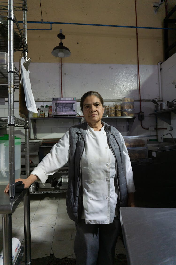 A Woman Working In A Restaurant Kitchen 