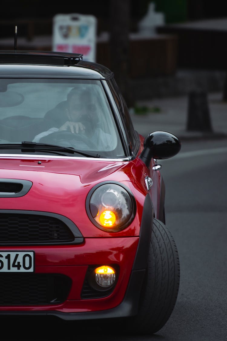 Man Driving Classic Red Mini Morris