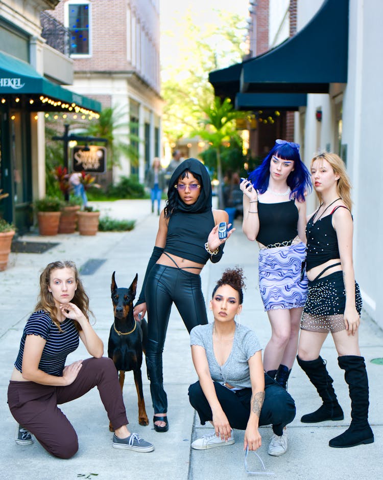 Group Of Girls Posing With Dog On Street