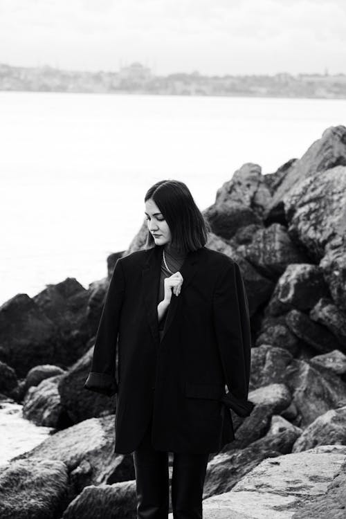A Woman Standing on a Seashore 