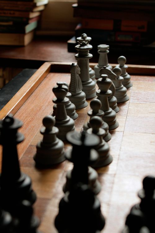 Free Close-up image of a chessboard with arranged pieces highlighting the game's strategy. Stock Photo