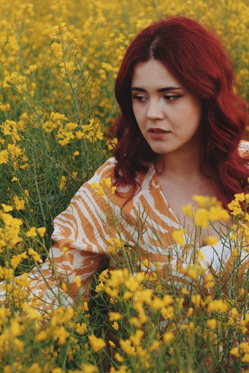 Redhead Woman Sitting on Meadow
