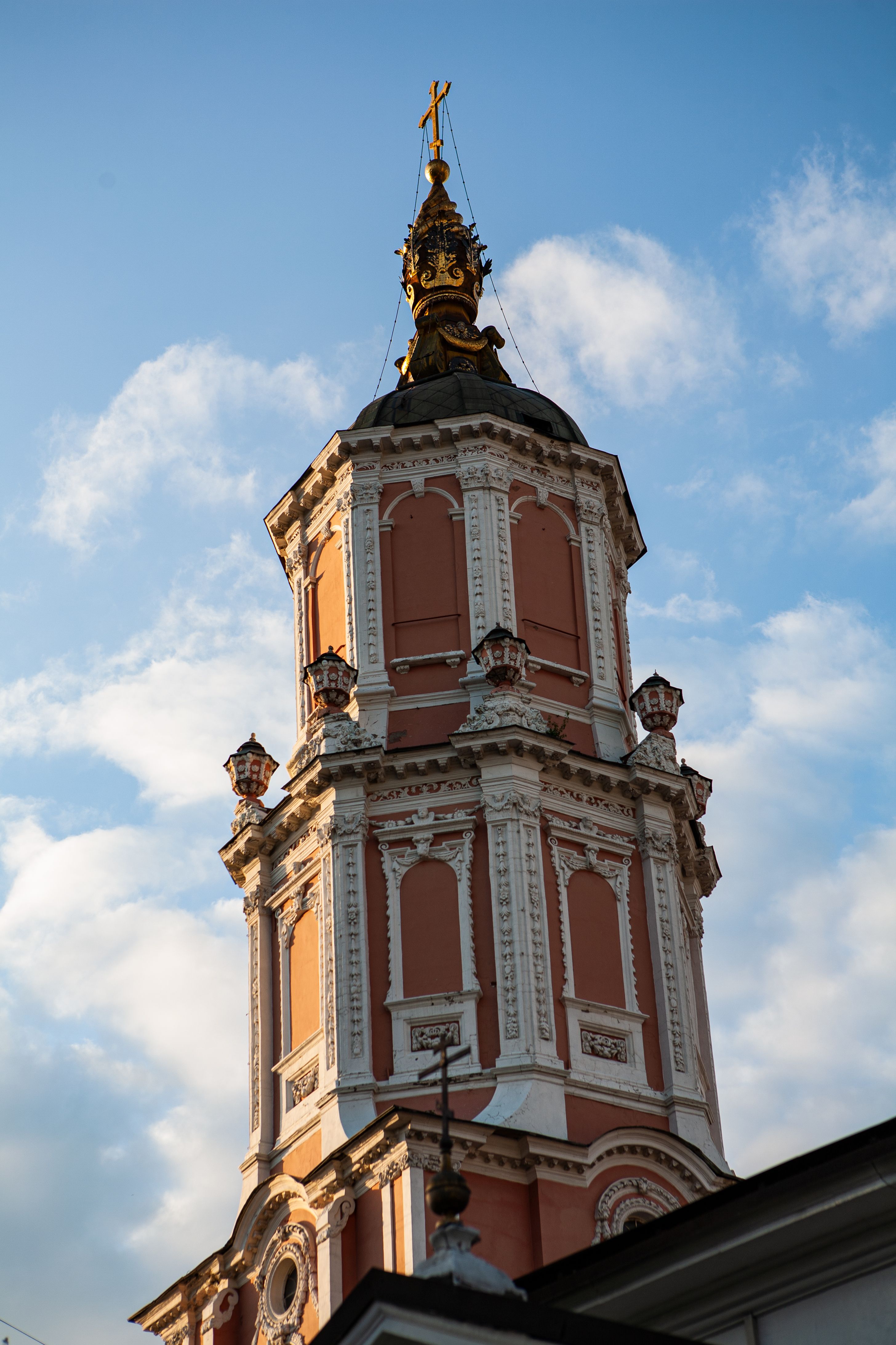 Vertical shot of Menshikov Tower, a Baroque Orthodox church in Moscow, Russia, against a blue sky.