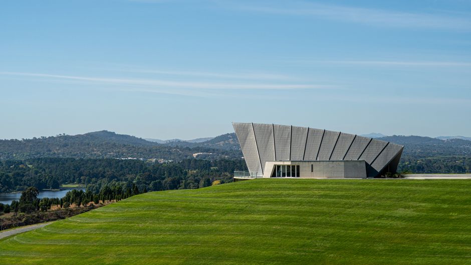 Scenic view of Margaret Whitlam Pavilion with hills and greenery in Canberra, Australia.