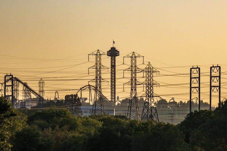 Silhouetted Electricity Poles And Lines At Sunset 