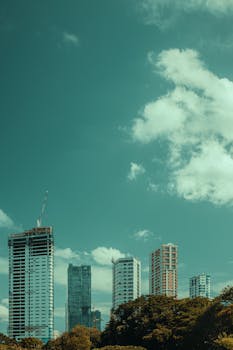 Skyscrapers in a vibrant urban landscape under a blue sky.