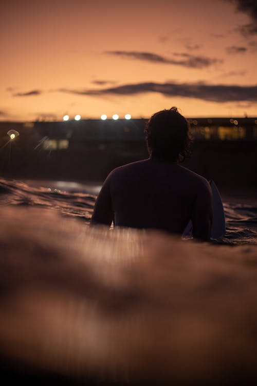 Surfer in Sea at Sunset
