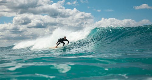 Man Surfing on Blue Waves 