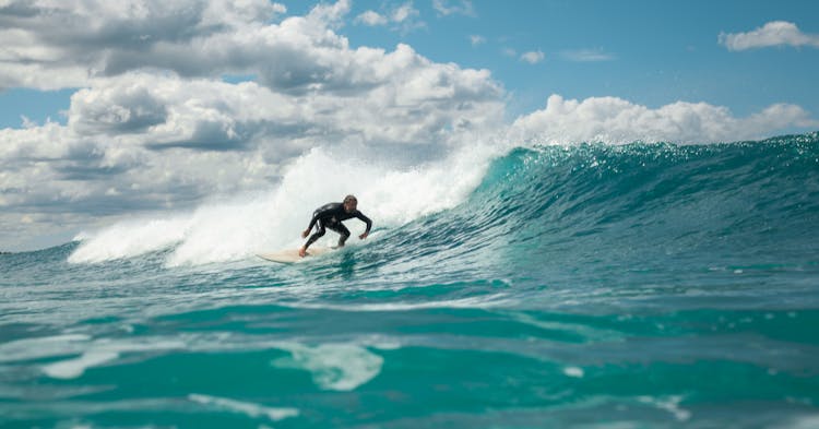 Man Surfing On Blue Waves 