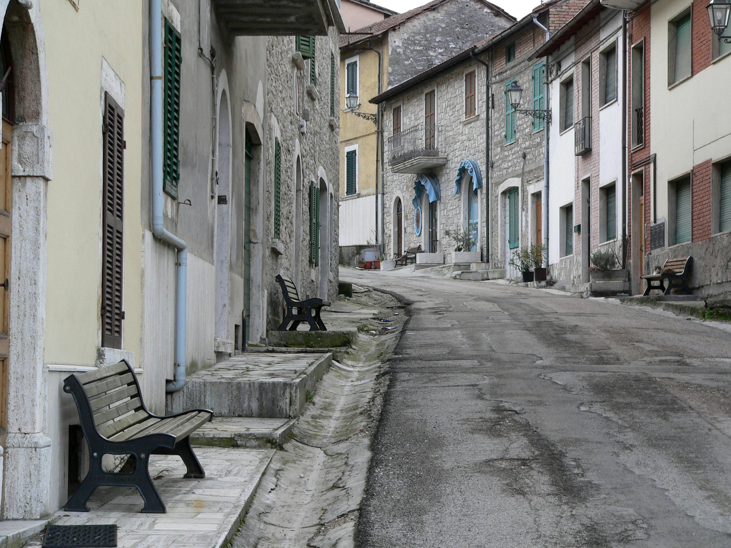 a street with benches and a bench on the side