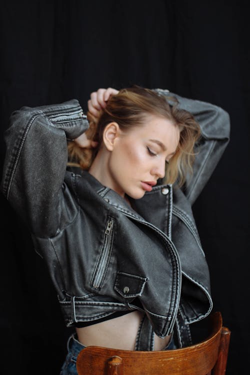 Woman in Leather Jacket Fixing Hair