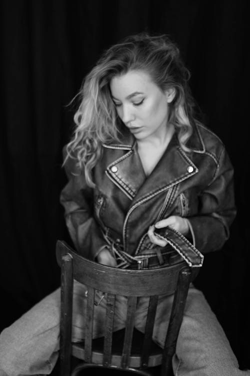 Model in a Leather Jacket Sitting Backward on a Chair