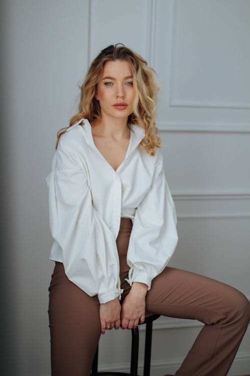 Model in a Loose White Blouse and Flared Pants