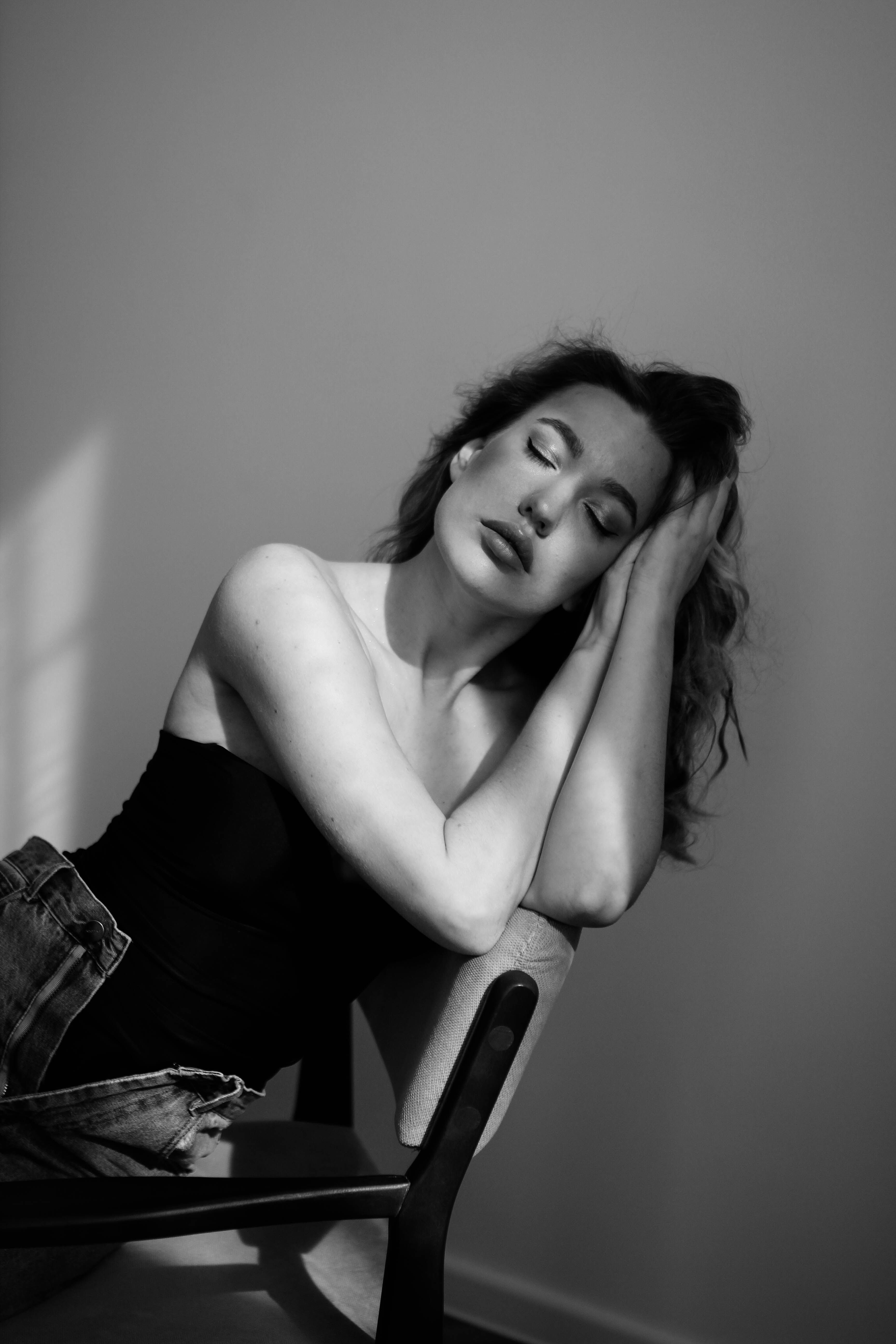 Fashion Model Posing on Chair in Black and White · Free Stock Photo