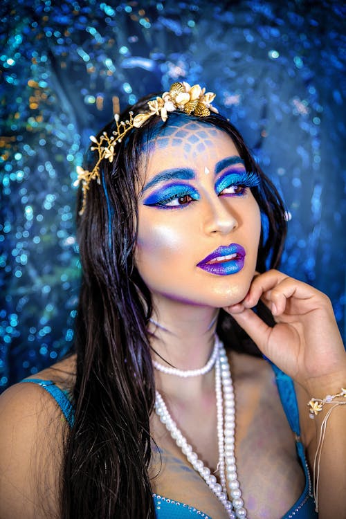 Portrait of a Long-Haired Brunette Wearing Blue Makeup