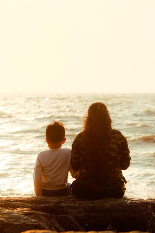 Mother Sitting with Son on Sea Shore