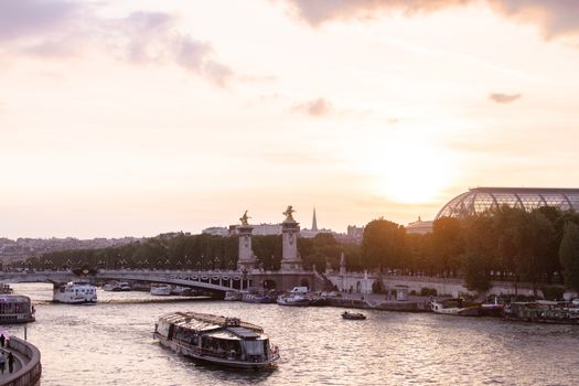 Scenic view of Paris with the Seine River and iconic architecture during sunset.