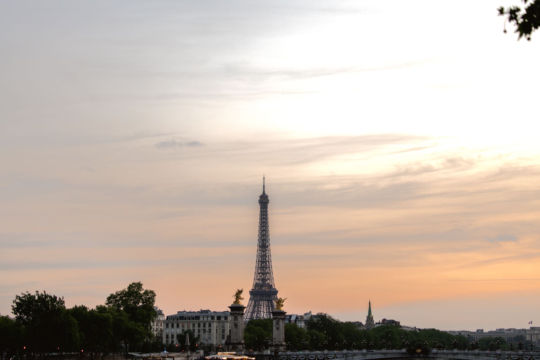 Beautiful view of the Eiffel Tower at sunset with a glowing sky in Paris, France.