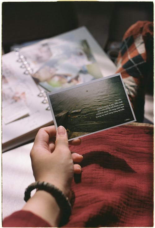 Woman Hand Holding Postcard