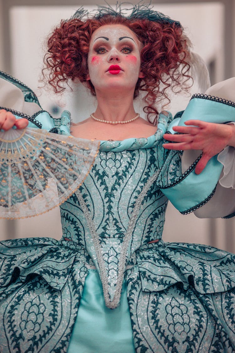 Woman In Costume Dress And With Fan