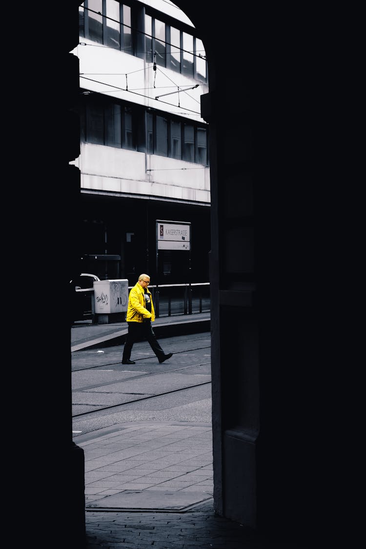 Man Crossing Street In Town