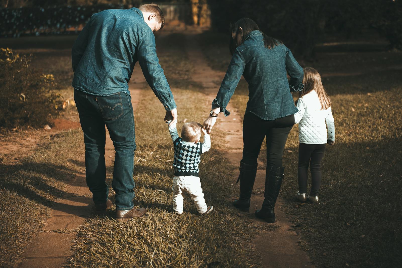 a family with young children walking on a path