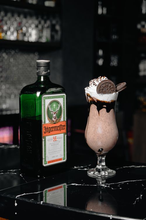 Free Decadent milkshake with Jägermeister and cookies on a modern bar countertop. Stock Photo