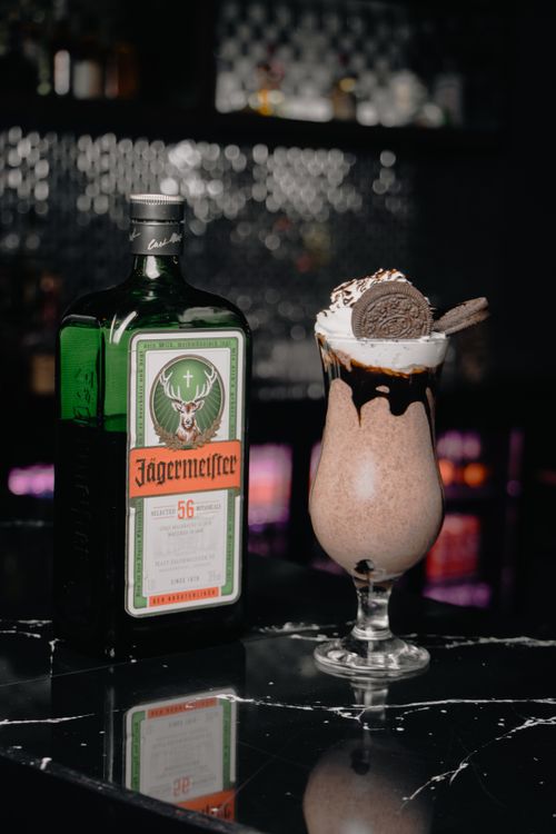 Free Delicious chocolate cocktail with Oreo and Jägermeister on a sleek bar counter. Stock Photo