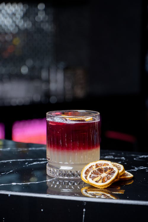 Fruit Slices near Cocktail in Glass