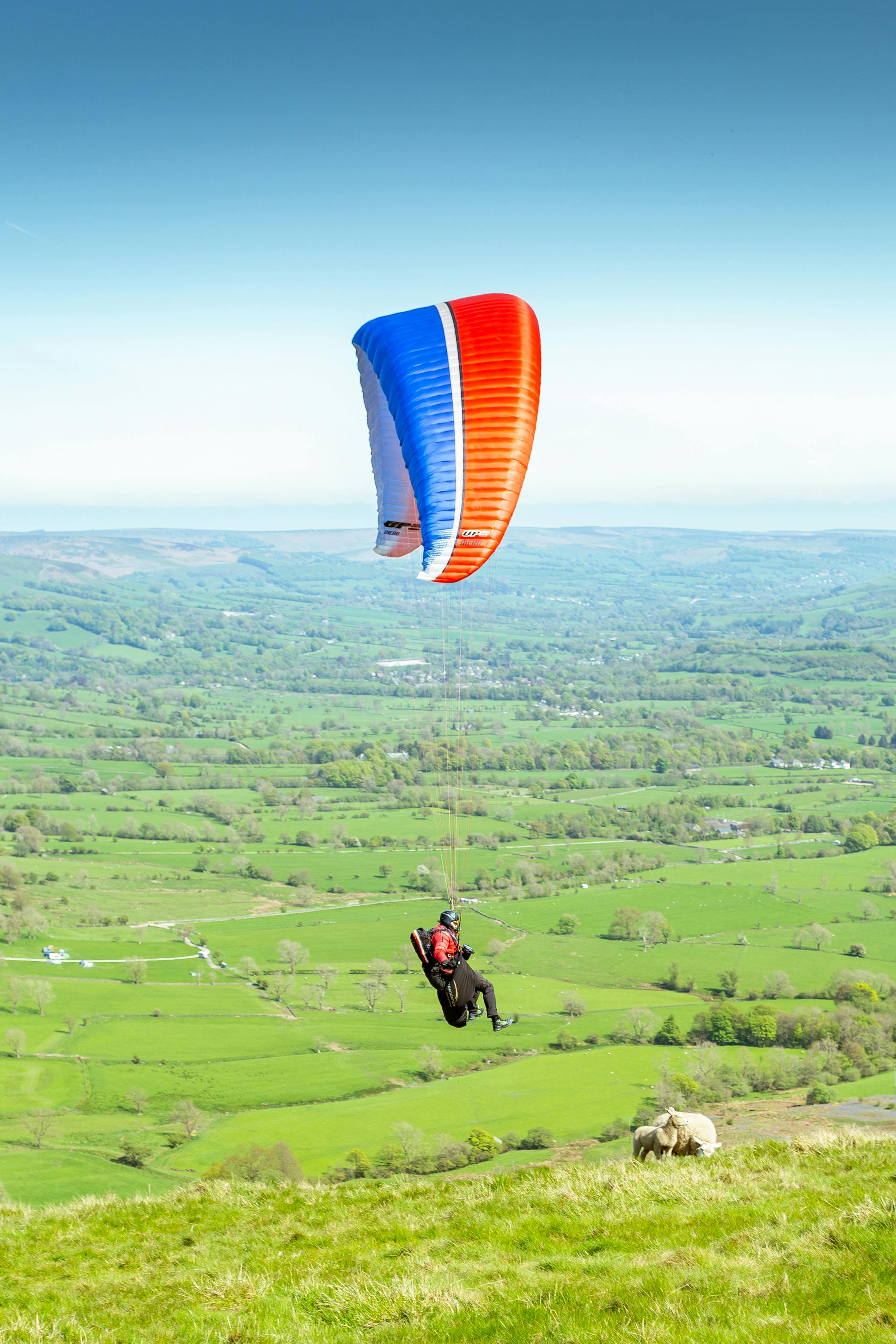 Person Paragliding over the Field · Free Stock Photo