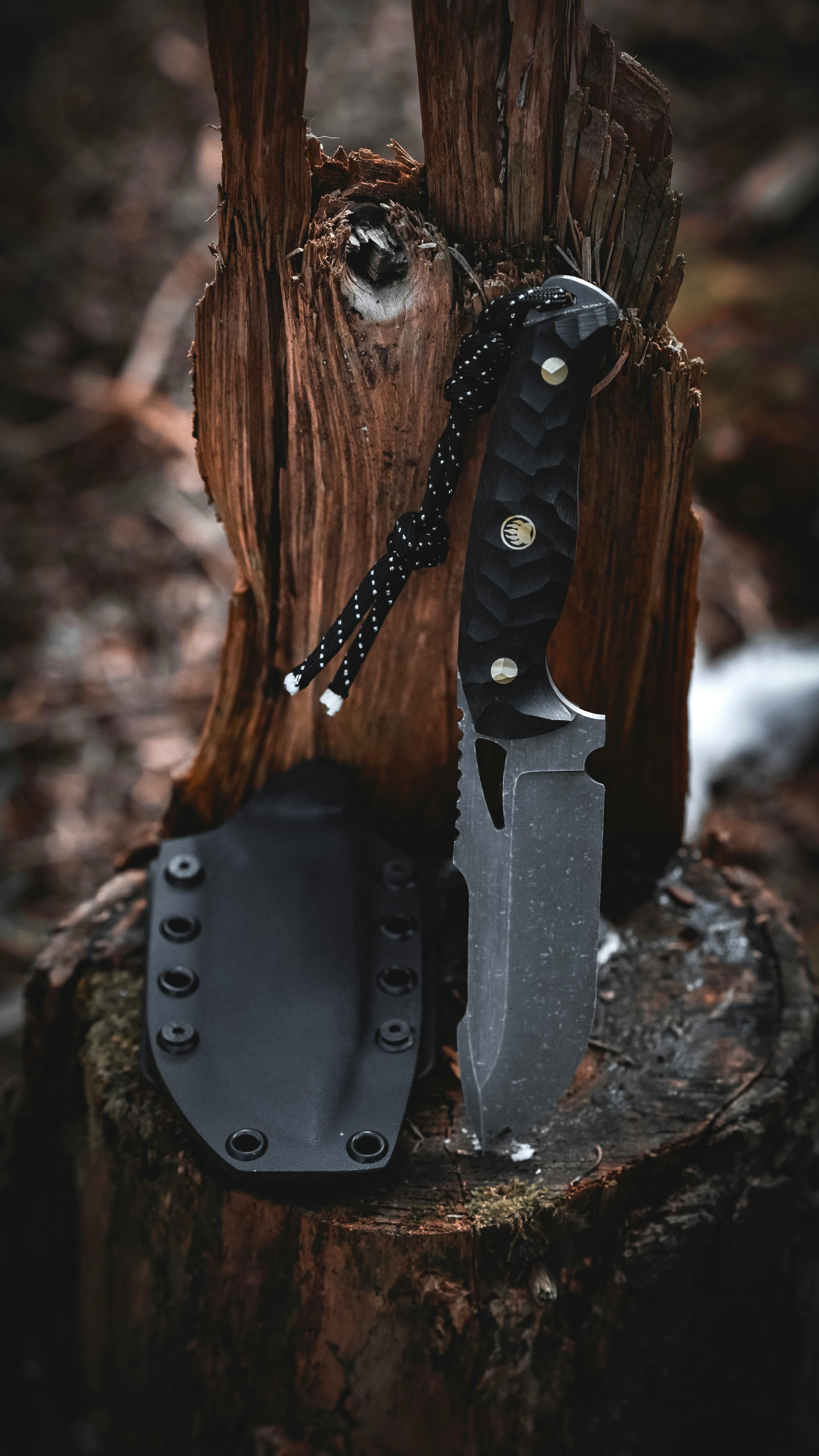 free photo of close up of a knife stuck in a tree stump