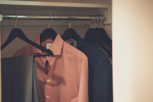 Close-up Photo of Hang Clothes in Wardrobe