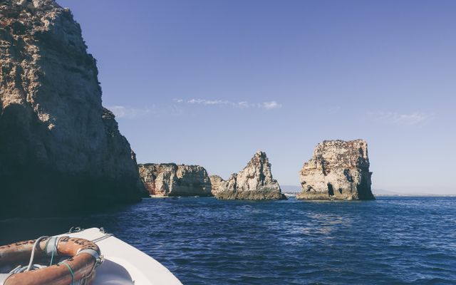 Photo: Ricky Esquivel on Pexels Tranquil scene of Algarve cliffs and ocean from a boat, ideal for travel and vacation themes.