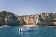 夏日乘船游览，在阳光下探索令人惊叹的岩石悬崖和清澈湛蓝的海水