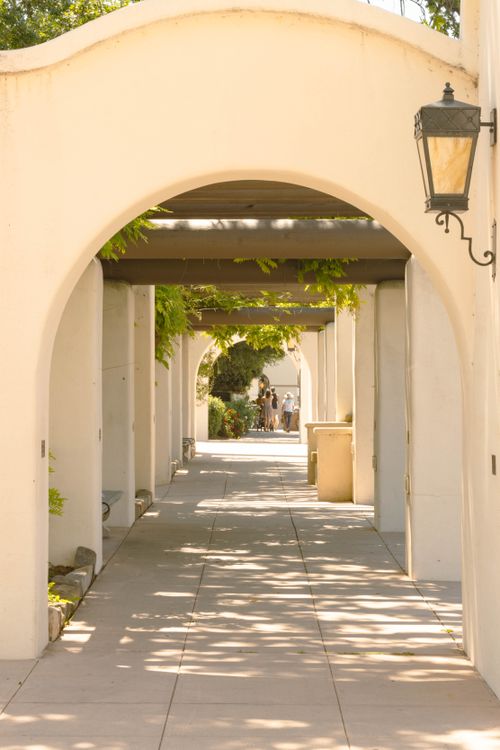 Free Charming sunlit walkway under Mediterranean arches in Ojai, California. Stock Photo