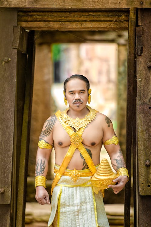 Man Posing in Golden, Traditional Clothing
