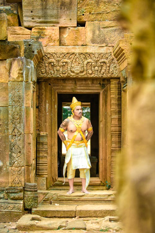 Man in Traditional Clothing Standing in the Doorway of the Temple 