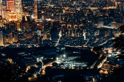 Free A breathtaking aerial view of a bustling city illuminated at night, showcasing vibrant skyscrapers and urban architecture. Stock Photo