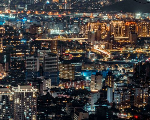 Free Stunning cityscape showcasing modern architecture illuminated at night from a high vantage point. Stock Photo