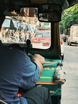 close up of man driving tuk tuk