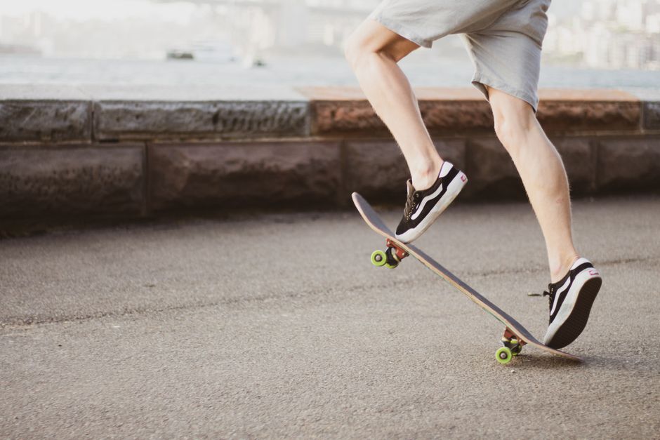A skateboarder performing a trick outdoors, showcasing urban lifestyle and motion.