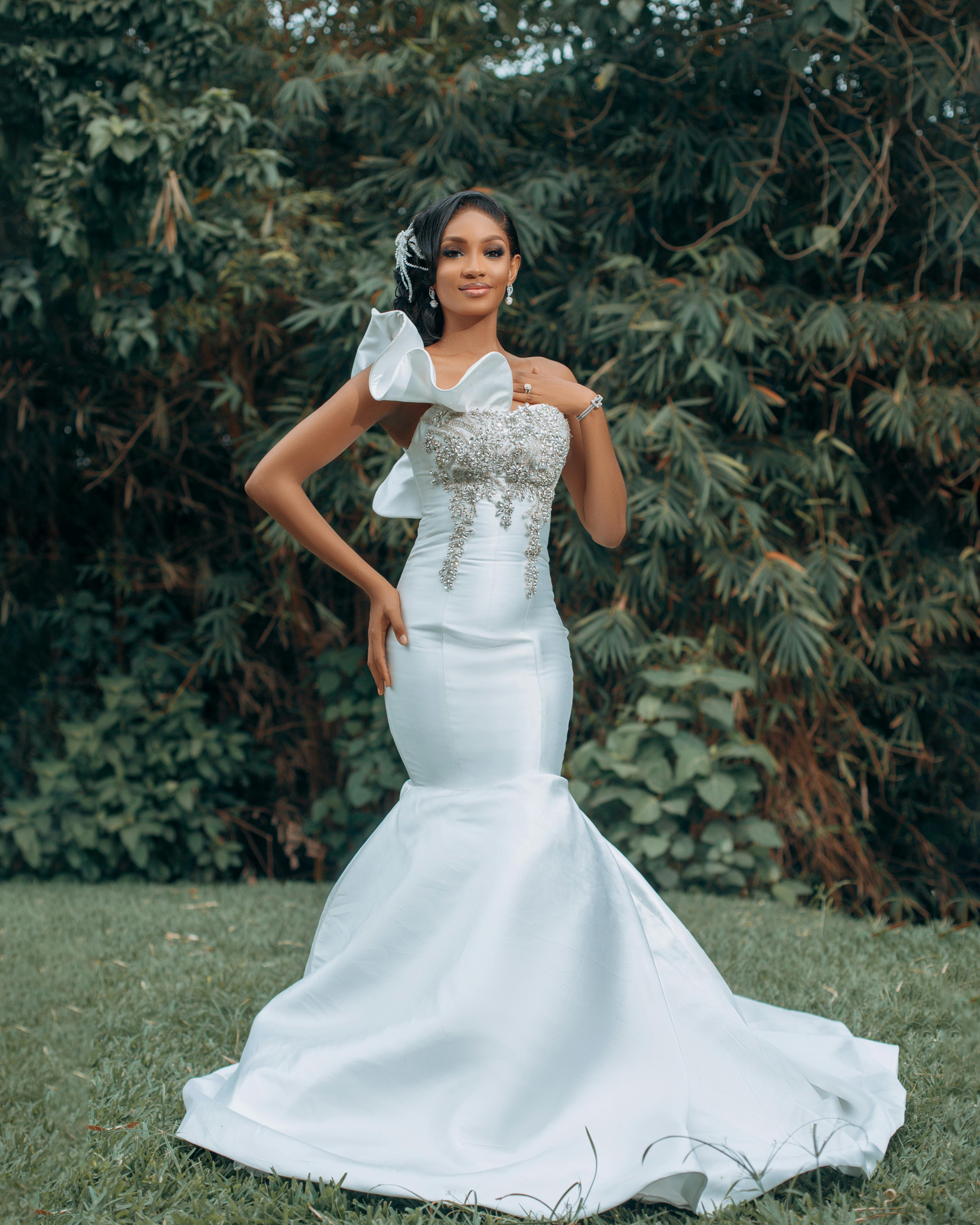 Young Beautiful Woman Posing in Elegant Wedding Dress in Garden