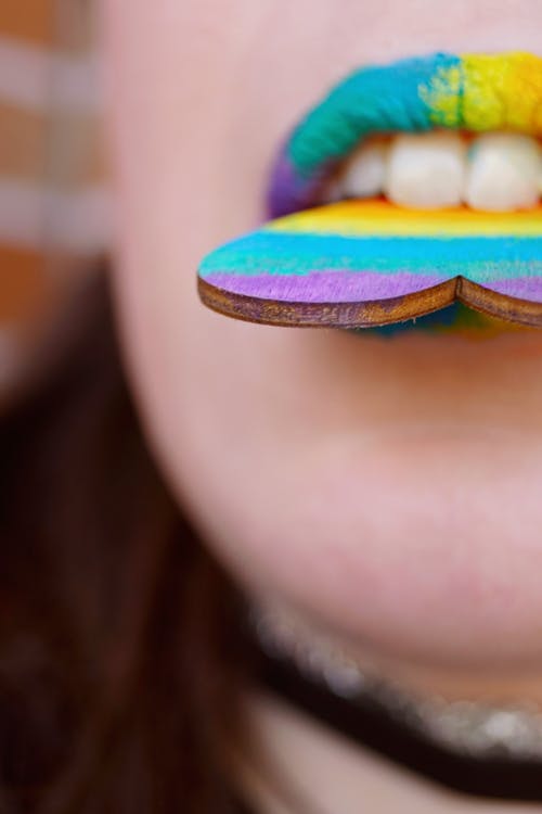 Close-Up Photo of Person Biting Heart Decor