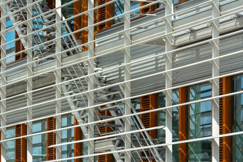 Free Detailed view of a building facade featuring metal structures and glass windows, highlighting urban architecture. Stock Photo