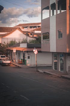 Charming urban street in Alto Rio Novo, Brazil, captured at sunset with empty roads and architecture.