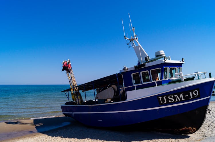 Blue Trawler On Beach