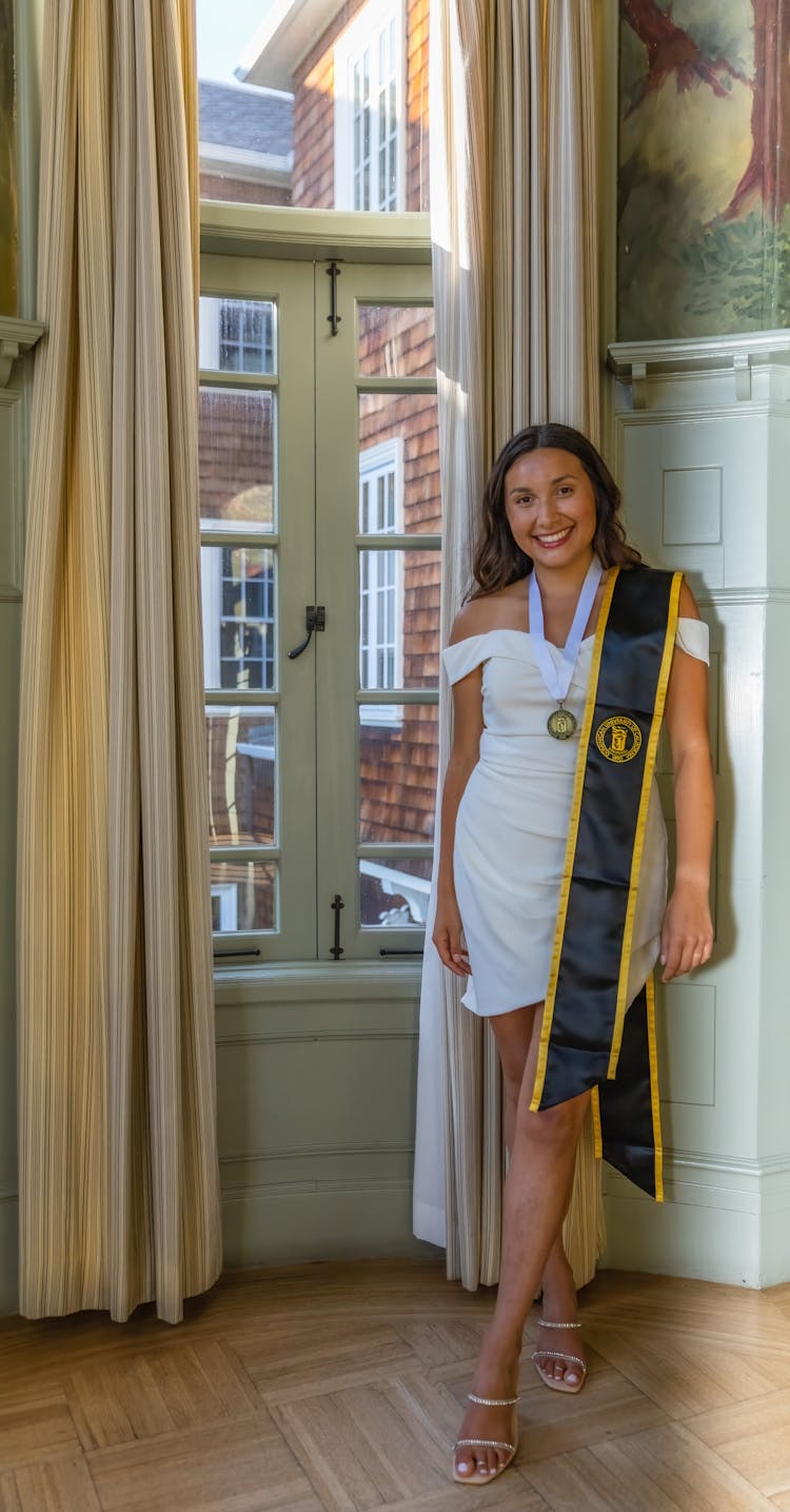 Smiling Graduate Posing With Medal